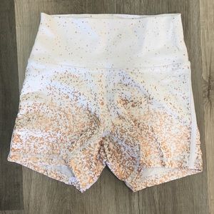 Buff Bunny white workout shorts with rose gold foil detailing.